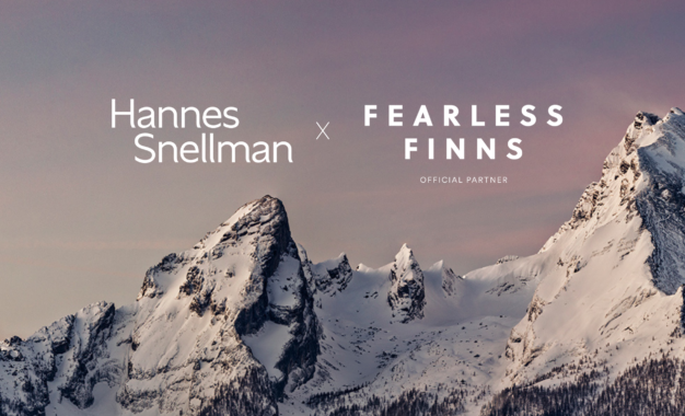 Snow-covered mountain peaks under a pink and purple sky, with the text “Hannes Snellman x Fearless Finns Official Partner” overlaid on the left and center of the image.