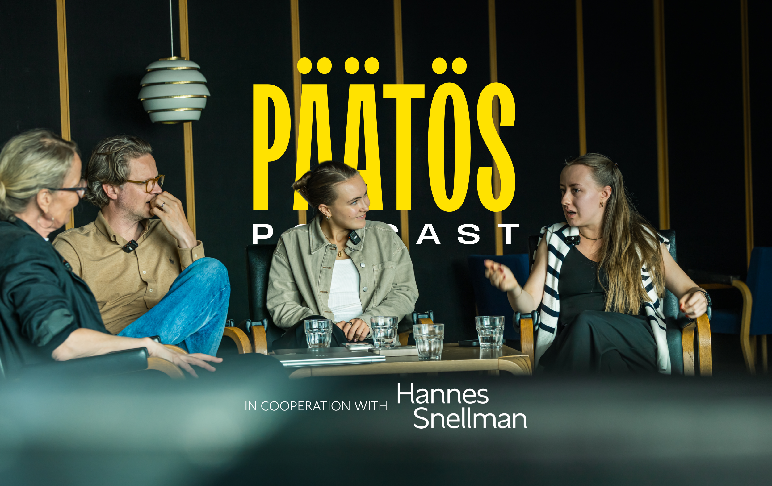 Four people sit and converse on a panel in front of a PÄÄTÖS PODCAST sign. Glasses of water and papers are on the table. In cooperation with Hannes Snellman text appears at the bottom.