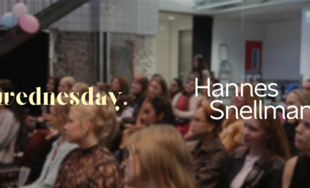 An audience sits in a dimly lit room, with the text wednesday. Hannes Snellman overlaid in the foreground.